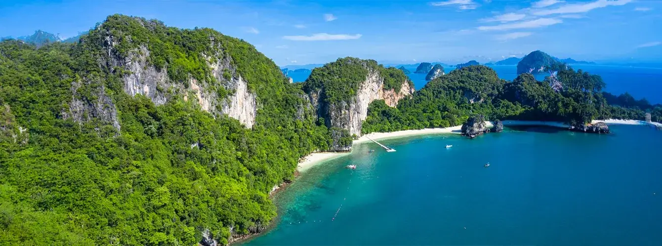 Scenic Phi Phi Islands in Krabi featured in Thailand tour packages with turquoise water, tropical beaches, and limestone cliffs.